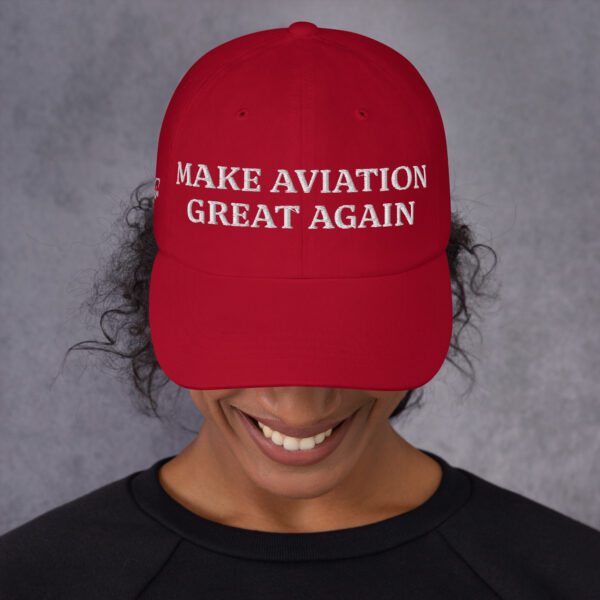 A woman wearing a hat that says " wake aviation great again ".