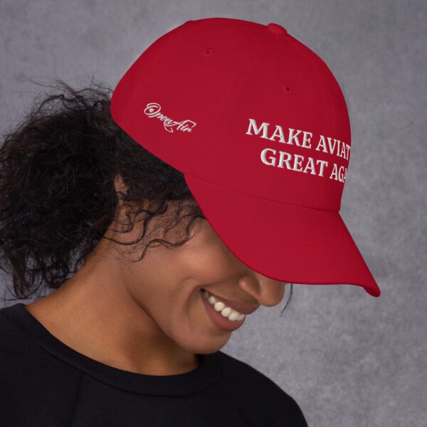 A woman wearing a red hat with the words " make america great again ".