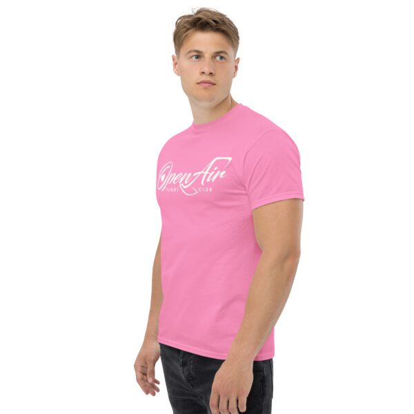 A man wearing a pink t-shirt with the word " gangster ".