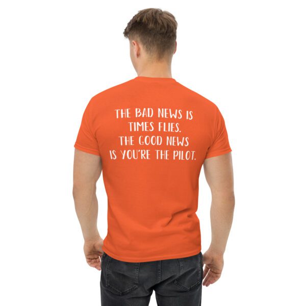 A man wearing an orange t-shirt with the words " for good news is you 're too poor ".