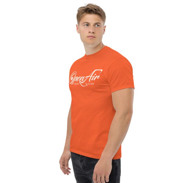 A man wearing an orange t-shirt with the words " strong as hell ".